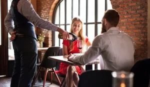 The waitress accidentally spilled a drink on my date — then secretly handed me a folded newspaper clipping that changed everything.