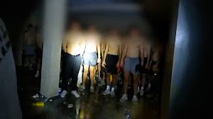 Horrifying discovery as police find 56 shirtless, blindfolded young men in basement